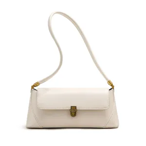 Detailed view of the elegant cream white shoulder bag with vintage bronze hardware.