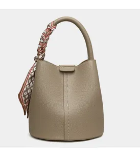 Elegant taupe leather bucket bag featuring a chic printed twilly scarf wrapped handle detail.