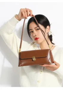 Brown soft leather shoulder bag for women, stylish minimalist handbag with metal lock for daily use.