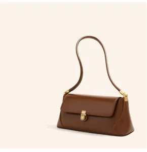 Brown leather shoulder bag with sleek gold hardware detail and minimalist flap design.