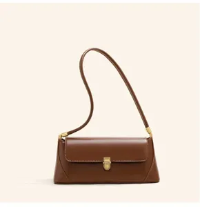 Brown leather shoulder bag detail, elegant gold metal clasp, minimalist design style.