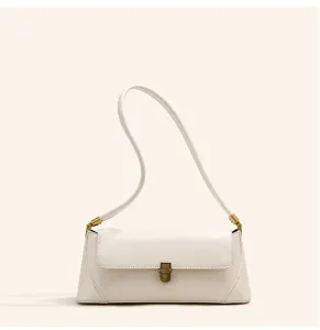 Close-up detail of the white leather shoulder bag, showing the gold metal clasp and soft texture.