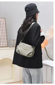 Detailed view of women casual crossbody bag shoulder bag, soft nylon material with pleats.