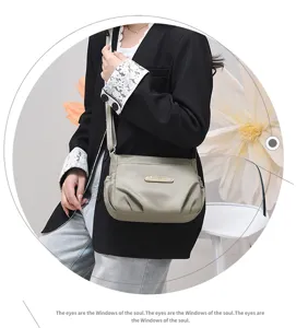 Detail view of the stylish casual crossbody shoulder bag worn by model, showing its pleated design.