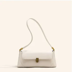 Elegant minimalist white shoulder bag for women, chic leather baguette handbag with vintage lock.