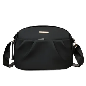 Black nylon crossbody bag for women, casual shoulder bag with adjustable strap and pockets.