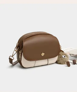 Color-blocked mini crossbody bag for women, soft leather stylish shoulder handbag with cute charm.
