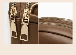 Women crossbody bag detail view, brown soft leather material, double zipper design, compact.