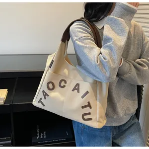 Large capacity canvas tote bag for women with stylish leather details and shoulder strap.