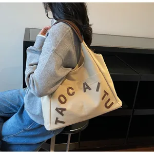 Large capacity canvas tote bag for women, stylish letter embroidery shoulder bag, casual commuting bag.