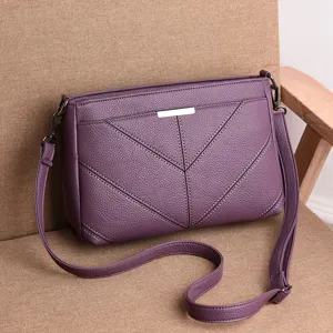 Purple leather shoulder bag for women, stylish crossbody handbag with soft material and chic strap.