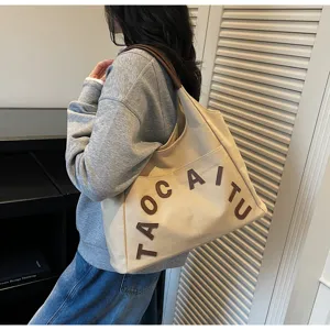 Large capacity canvas shoulder tote bag with brown letter embroidery for daily commute.