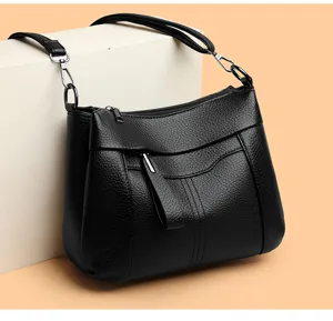 Detail shot of the black leather women shoulder bag, showing fine texture and metal zipper.
