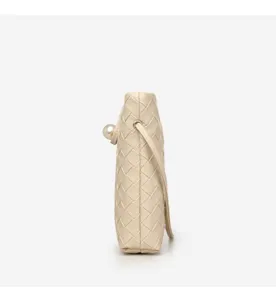 Beige woven leather crossbody bag with pearl detail, chic mini shoulder bag for women.