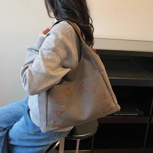 Large capacity canvas tote bag for women with letter embroidery, stylish commuting shoulder bag.