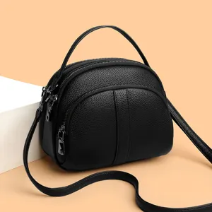 Black leather crossbody bag for women, stylish versatile shoulder shell bag with handle.