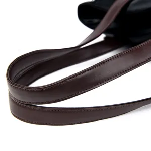 Close-up of brown leather handbag strap showing fine stitching and premium texture details.