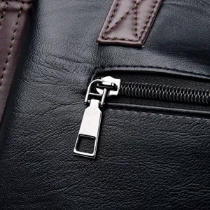 Close-up detail of black soft leather women handbag zipper and stitching texture.