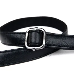 Black leather handbag strap detail view featuring a durable silver metal adjustable buckle.