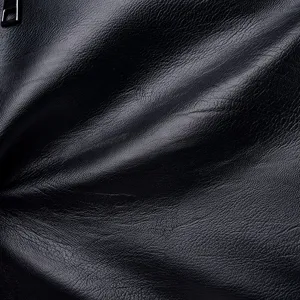 Close-up detail view of black soft leather handbag material texture with a metal zipper pull.