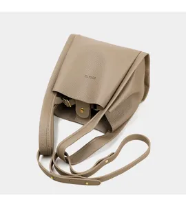 Vista detallada del bolso tipo cubo taupe casual con correa ajustable y herrajes.