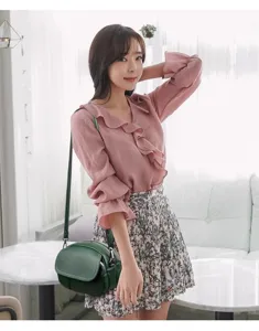 Stylish minimalist mini crossbody bag for women, versatile small round shoulder bag in soft leather.