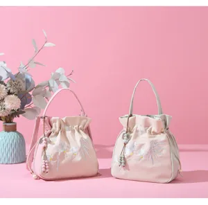 Detailed view of Chinese style embroidered bucket bag with floral motifs and beads
