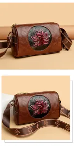 Vintage Chinese style barrel crossbody bag for women, retro embossed lotus PU leather purse.