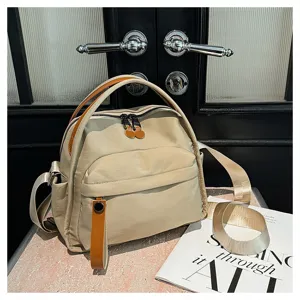 Detailed shot of casual nylon backpack with leather handles, perfect for daily commuting use.