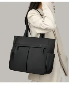 Black nylon commute tote bag detail, side pockets and zipper design for office work.