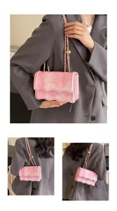 Detailed view of the pink wavy chain shoulder bag showcasing its stylish design and texture.