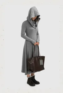 Detail view of large soft leather women tote bag, stylish commuter shoulder bag in daily use.