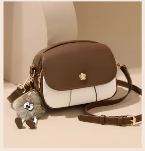 Chic contrast color crossbody bag for women, soft leather mini shoulder bag with cute fluffy charm.