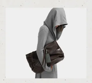 Detail view of large brown soft leather slouchy tote bag, elegant minimalist design for use.