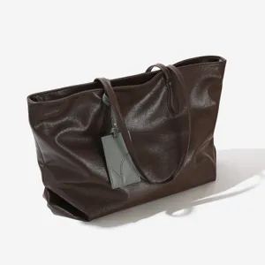 Large capacity brown leather tote bag for women, stylish commuting shoulder bag with tag.