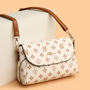 Stylish women's shoulder crossbody bag with vintage monogram pattern and brown strap.