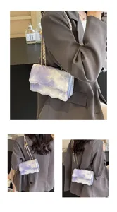 Close-up detail showing the purple marble wave texture and metal chain strap of the shoulder bag.