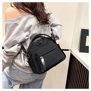Detailed view of casual black shoulder bag, versatile daily commuting backpack and handbag.