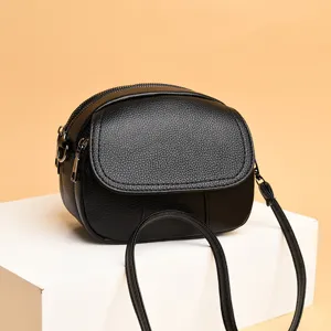 Detail view of a stylish black mini leather crossbody bag, compact and chic for daily wear.