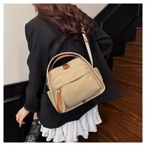 Casual nylon crossbody bag for women, stylish beige shoulder handbag with large capacity.