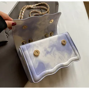 Stylish purple gradient wavy shoulder bag with chain strap and magnetic snap closure design.