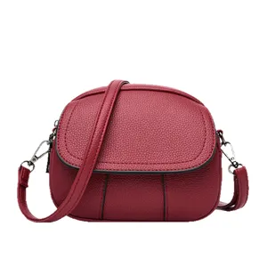 Red minimalist mini crossbody bag for women, trendy chic soft leather shoulder handbag.