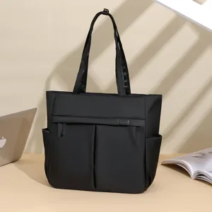 Minimalist black nylon commuter tote bag, versatile shoulder bag for women work office.