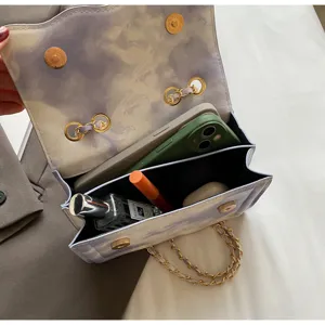 Detailed view of the stylish chain crossbody bag with elegant wavy flap and ample interior space.