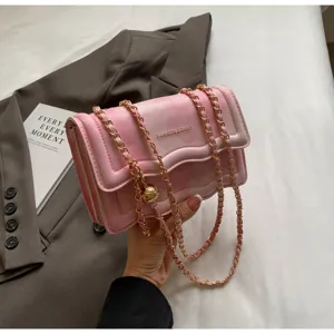 Pink gradient quilted chain shoulder bag detail, stylish wavy flap crossbody bag close-up.