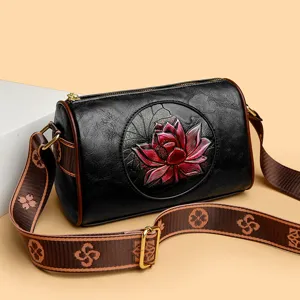 Black leather barrel handbag for women with embossed lotus flower, retro crossbody bag.