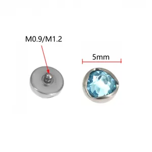 Titanium Piercing Schmuck mit wellenförmiger Einfassung und hellem blauem Kristall, 5 mm.