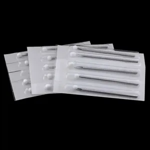 Detailed view of disposable piercing needles in individual sterile blister packaging, 316L steel.