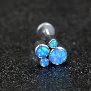 Detailed shot of 316L stainless steel cat paw synthetic opal labret stud cartilage piercing.