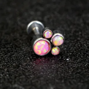 Detailed close-up of a stainless steel cat claw labret stud with pink opal body piercing jewelry.